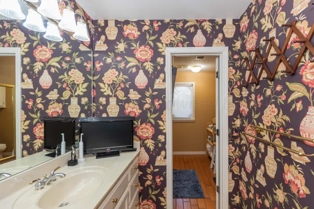 a view of an empty room with window and cabinet