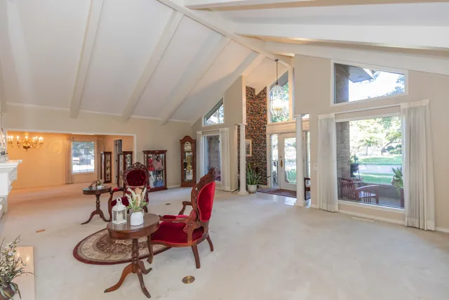 a view of a hallway with wooden floor and a bathroom