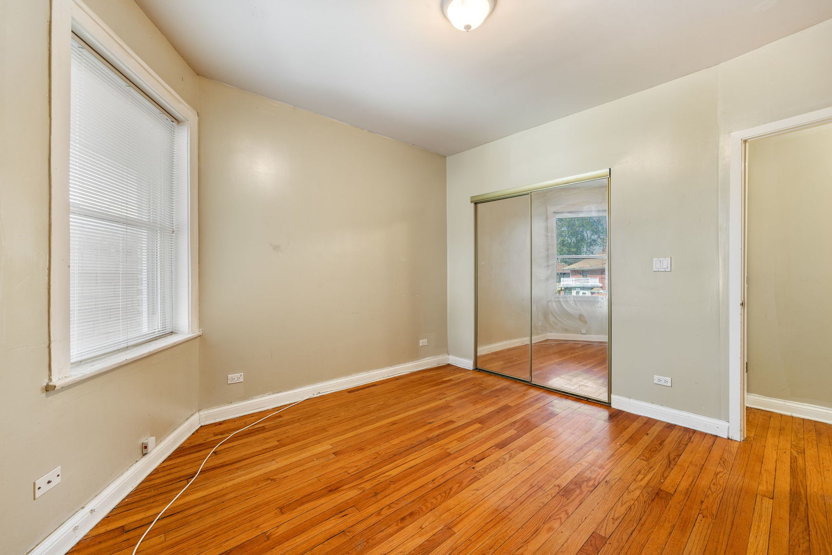 7416 South Yates Boulevard, Unit 2 Chicago, IL 60649 - Photo 11 of 16 a view of empty room with wooden floor