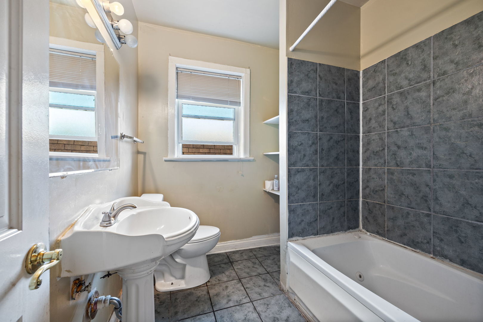 7416 South Yates Boulevard, Unit 2 Chicago, IL 60649 - Photo 12 of 16 a bathroom with a sink a toilet and bathtub