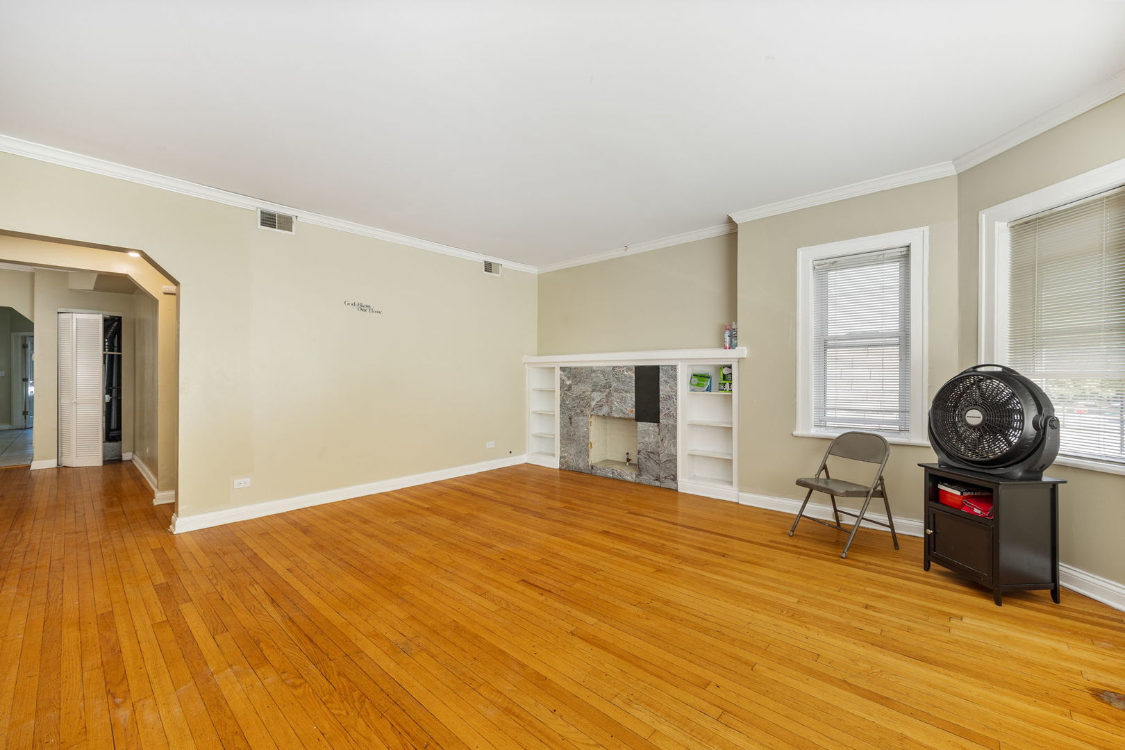7416 South Yates Boulevard, Unit 2 Chicago, IL 60649 - Photo 3 of 16 a bedroom with a bed and a chair in it