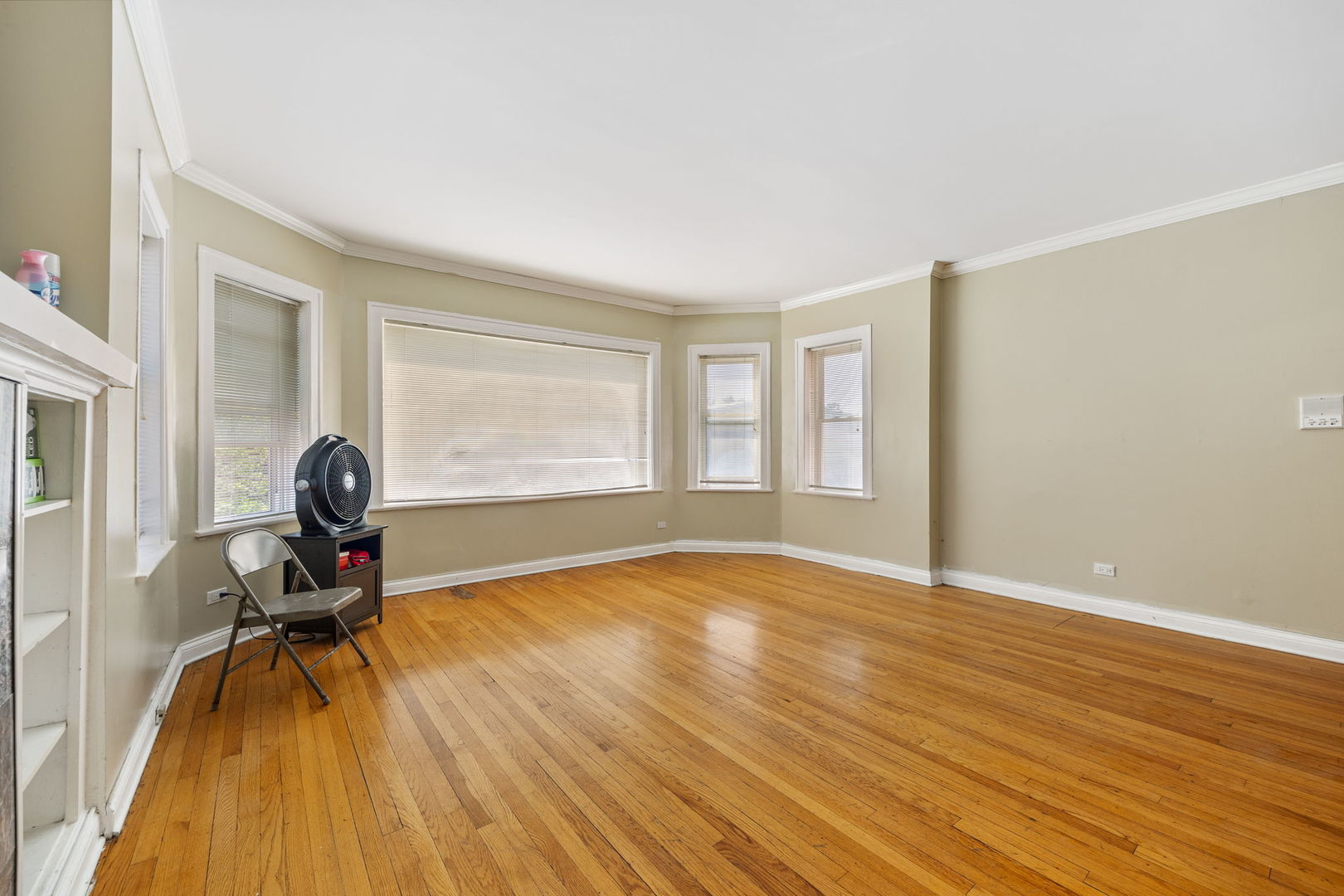 7416 South Yates Boulevard, Unit 2 Chicago, IL 60649 - Photo 4 of 16 a view of a room with wooden floor and windows
