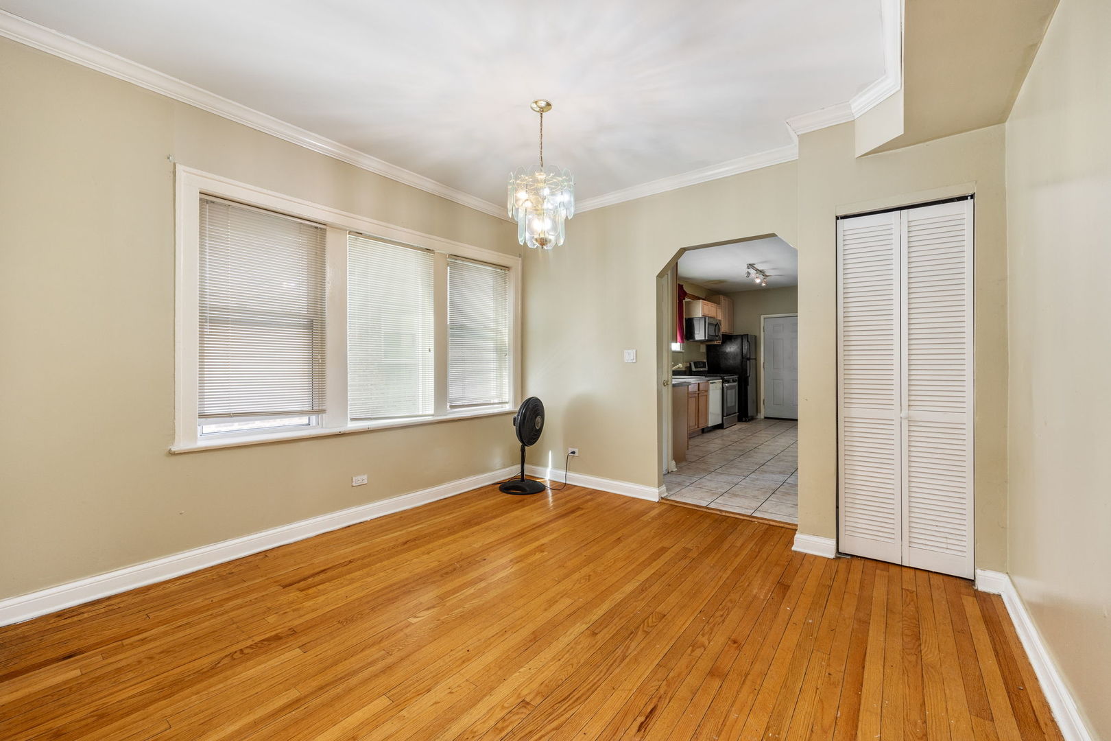 7416 South Yates Boulevard, Unit 2 Chicago, IL 60649 - Photo 5 of 16 a view of a room with wooden floor closet and windows