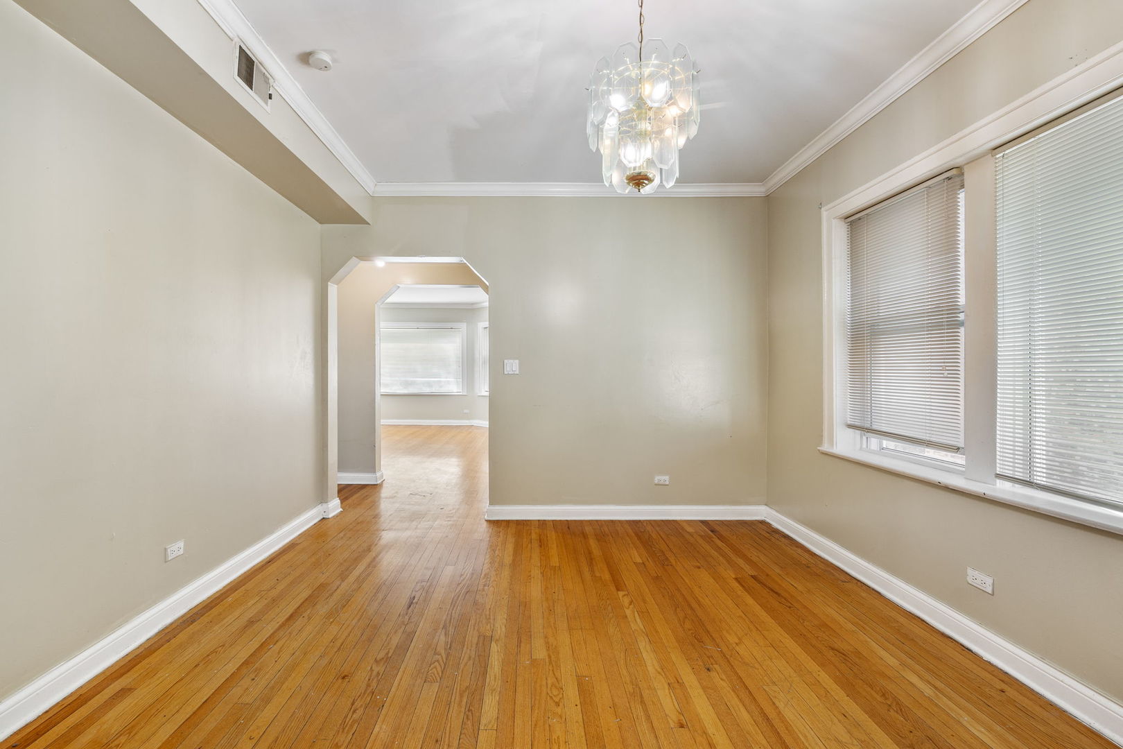 7416 South Yates Boulevard, Unit 2 Chicago, IL 60649 - Photo 6 of 16 wooden floor in an empty room with a window