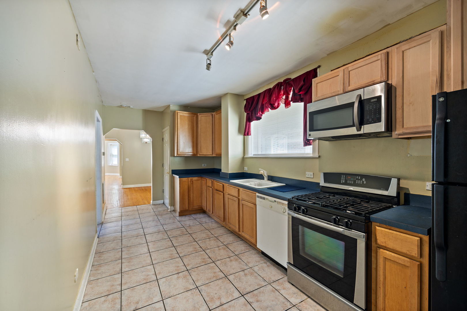 7416 South Yates Boulevard, Unit 2 Chicago, IL 60649 - Photo 8 of 16 a kitchen with stainless steel appliances granite countertop a stove a sink and a microwave