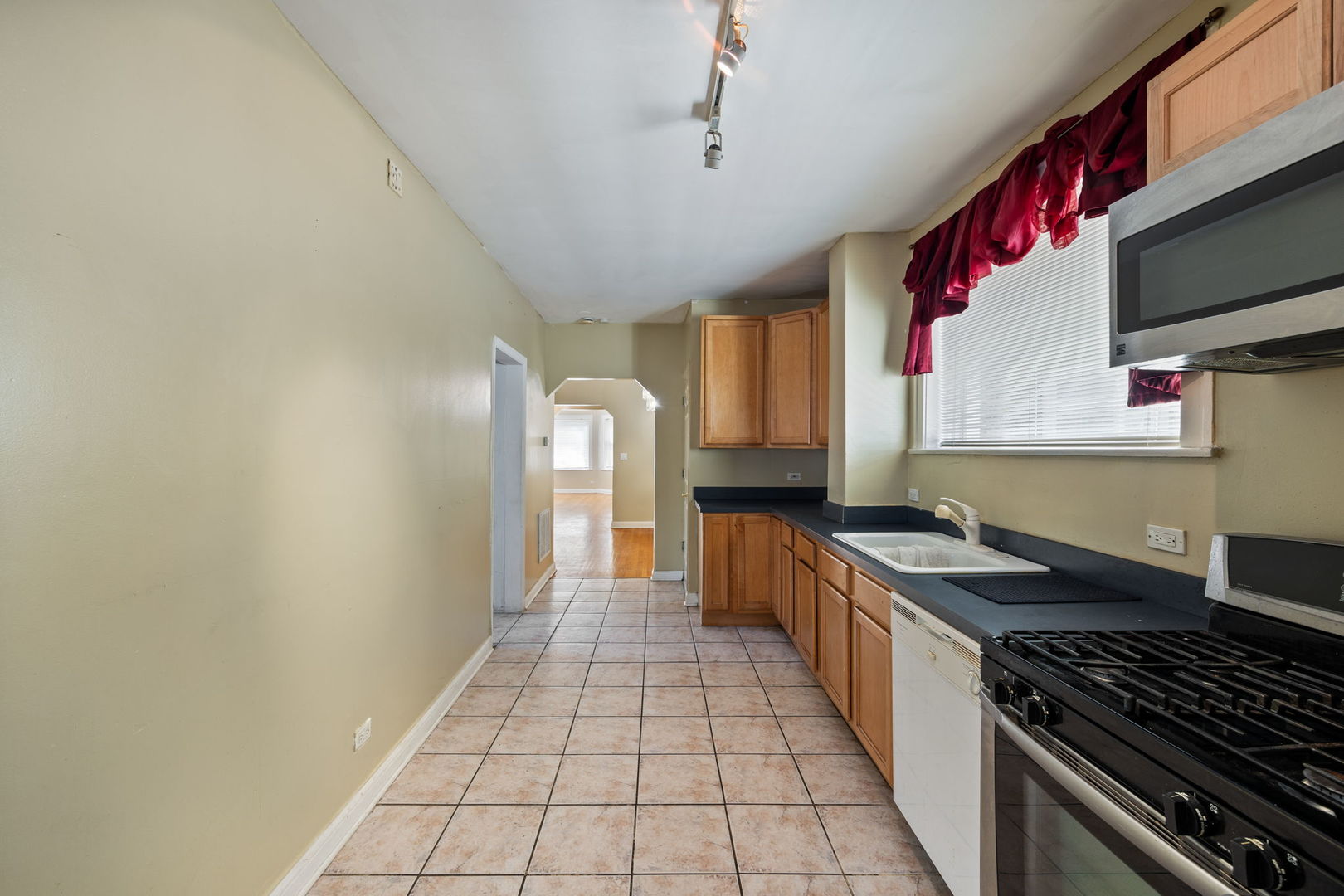 7416 South Yates Boulevard, Unit 2 Chicago, IL 60649 - Photo 9 of 16 a kitchen with stainless steel appliances granite countertop a stove and a sink