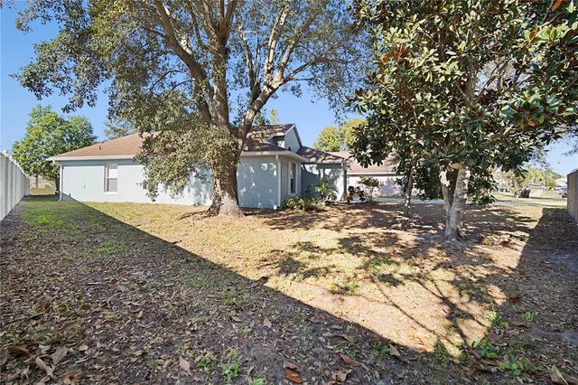 a view of a yard with large trees