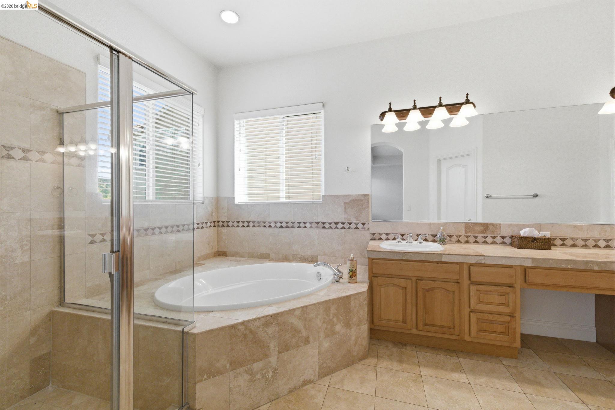 32 Apollo Lane Copperopolis, CA 95228 - Photo 27 of 58 Bathroom featuring vanity, a garden tub, a shower stall, light tile patterned flooring, and recessed lighting