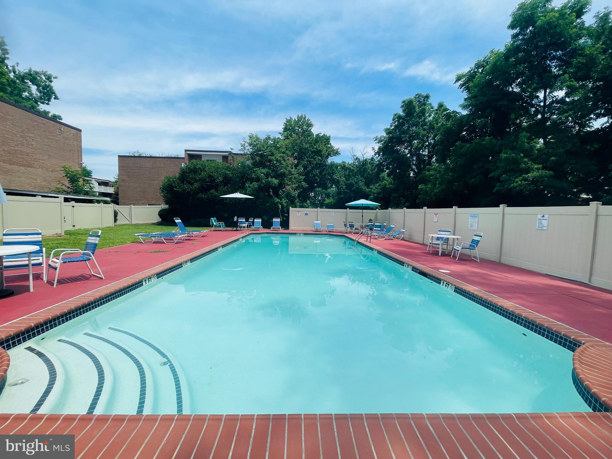 46 Township Line Road, Unit 215 Elkins Park, PA 19027 - Photo 17 of 17 an outdoor space with furniture and swimming pool