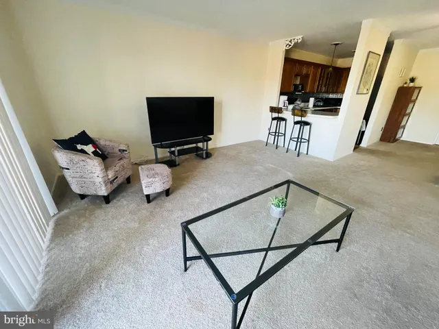 a bedroom with furniture and a flat screen tv