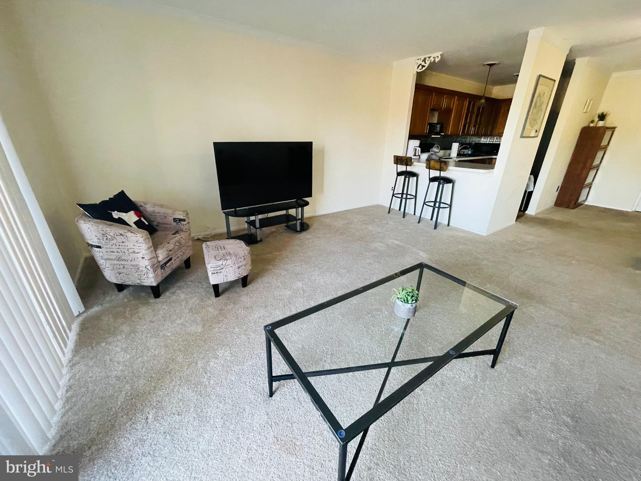 46 Township Line Road, Unit 215 Elkins Park, PA 19027 - Photo 2 of 17 a bedroom with furniture and a flat screen tv