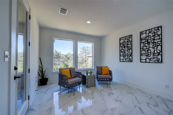 a living room with furniture and floor to ceiling window