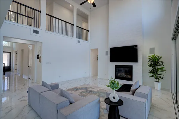 a living room with furniture large window and glass door