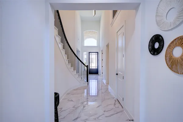 a view of entryway and hall with wooden floor