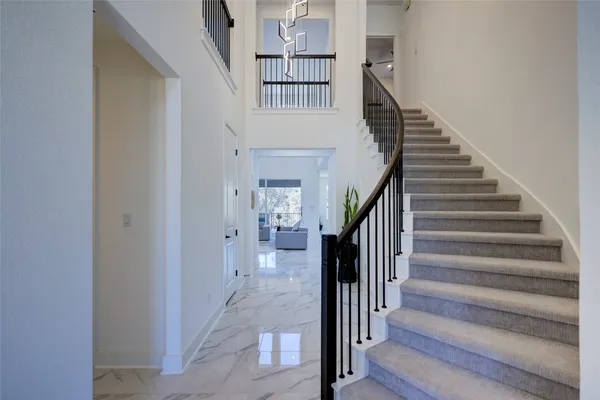 a spacious bedroom with a bed and a large window