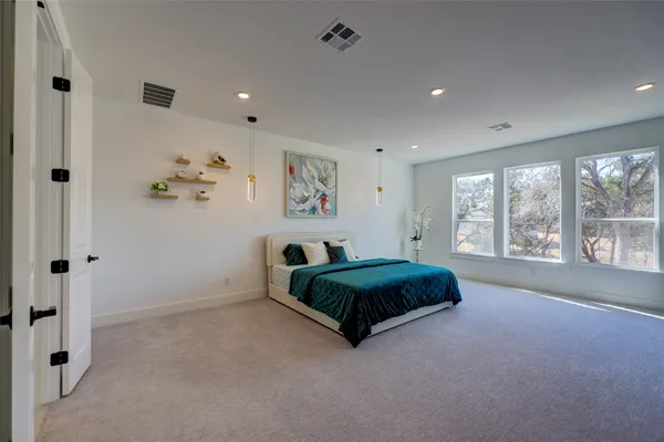 a living room with a bed and a painting