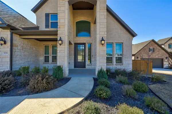 a front view of a house with garden