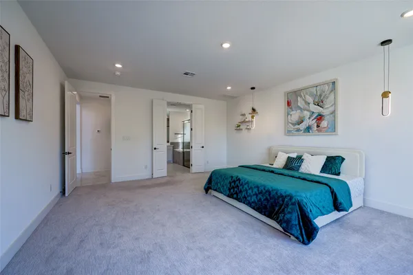 a bathroom with a double vanity sink a large mirror a bathtub and shower