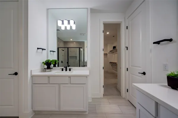 a spacious bathroom with a sink a large mirror and a bathtub