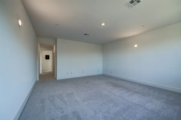a bedroom with a bed and painting on the wall