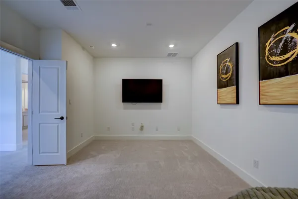 a spacious bedroom with a bed and a window