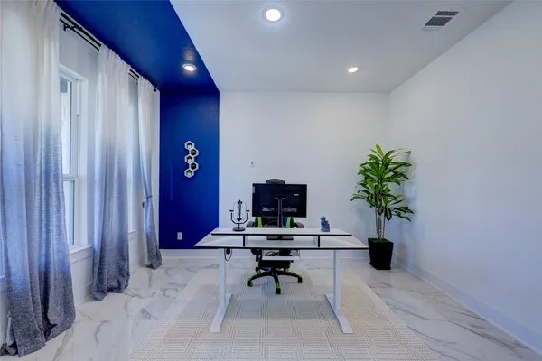 a workspace with furniture and a potted plant