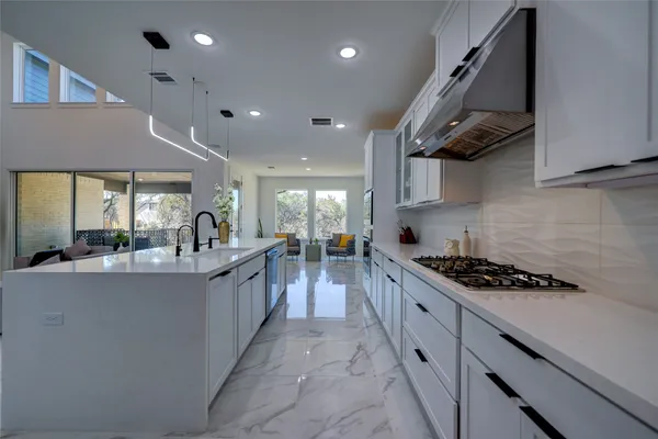 a kitchen with stainless steel appliances a stove sink and cabinets