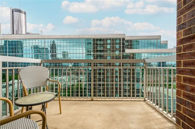 a view of a chair and table in the back yard of the house