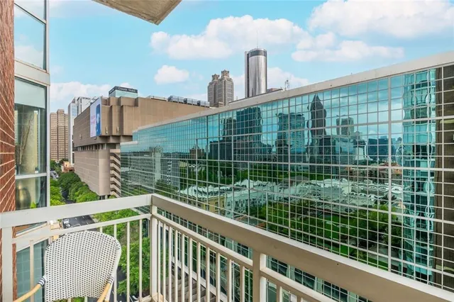 a view of a deck with two chair and a fireplace