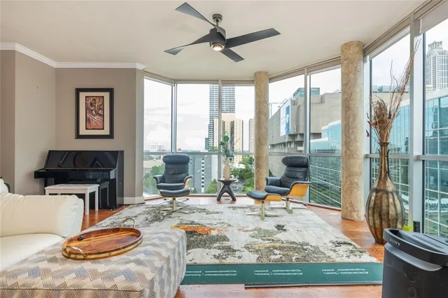 a room with furniture a flat screen tv and a table