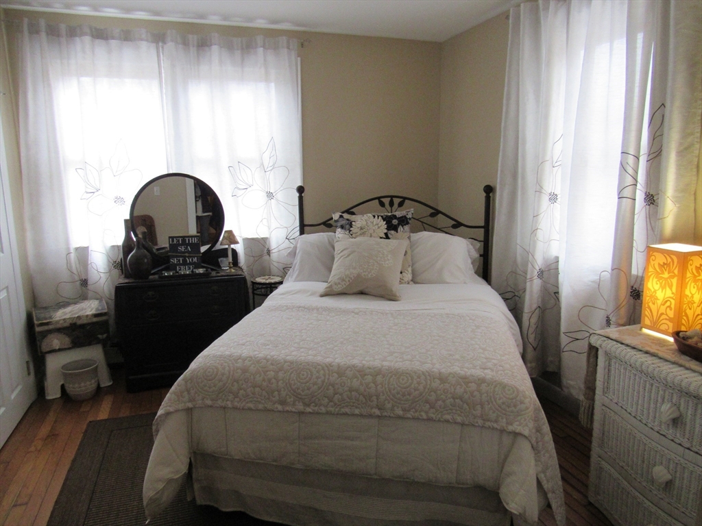 96 Main Street, Unit 1 Blackstone, MA 01504 - Photo 13 of 16 a bedroom with a bed and a flat tv screen on the dresser