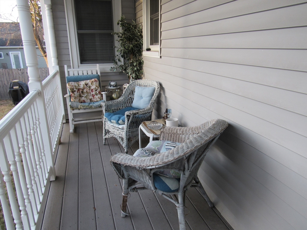 96 Main Street, Unit 1 Blackstone, MA 01504 - Photo 15 of 16 a view of balcony with wooden floor and outdoor seating
