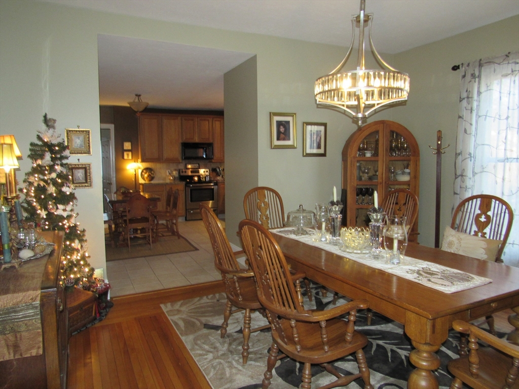 96 Main Street, Unit 1 Blackstone, MA 01504 - Photo 3 of 16 a view of a dining room with furniture and chandelier