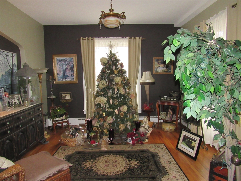 96 Main Street, Unit 1 Blackstone, MA 01504 - Photo 8 of 16 a living room with furniture and a potted plant