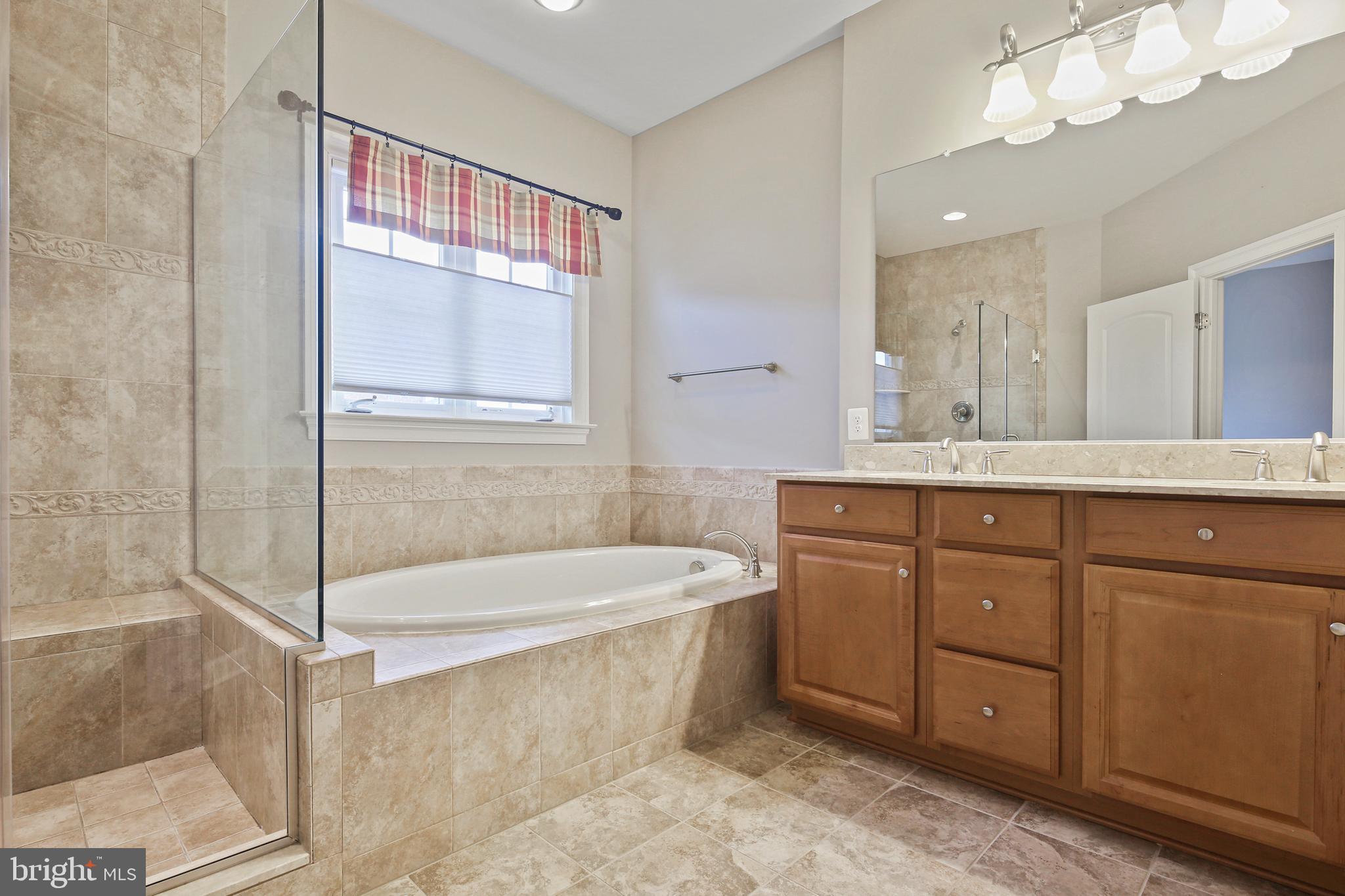 3553 Katherine Way Frederick, MD 21704 - Photo 14 of 34 a spacious bathroom with a tub sink and mirror