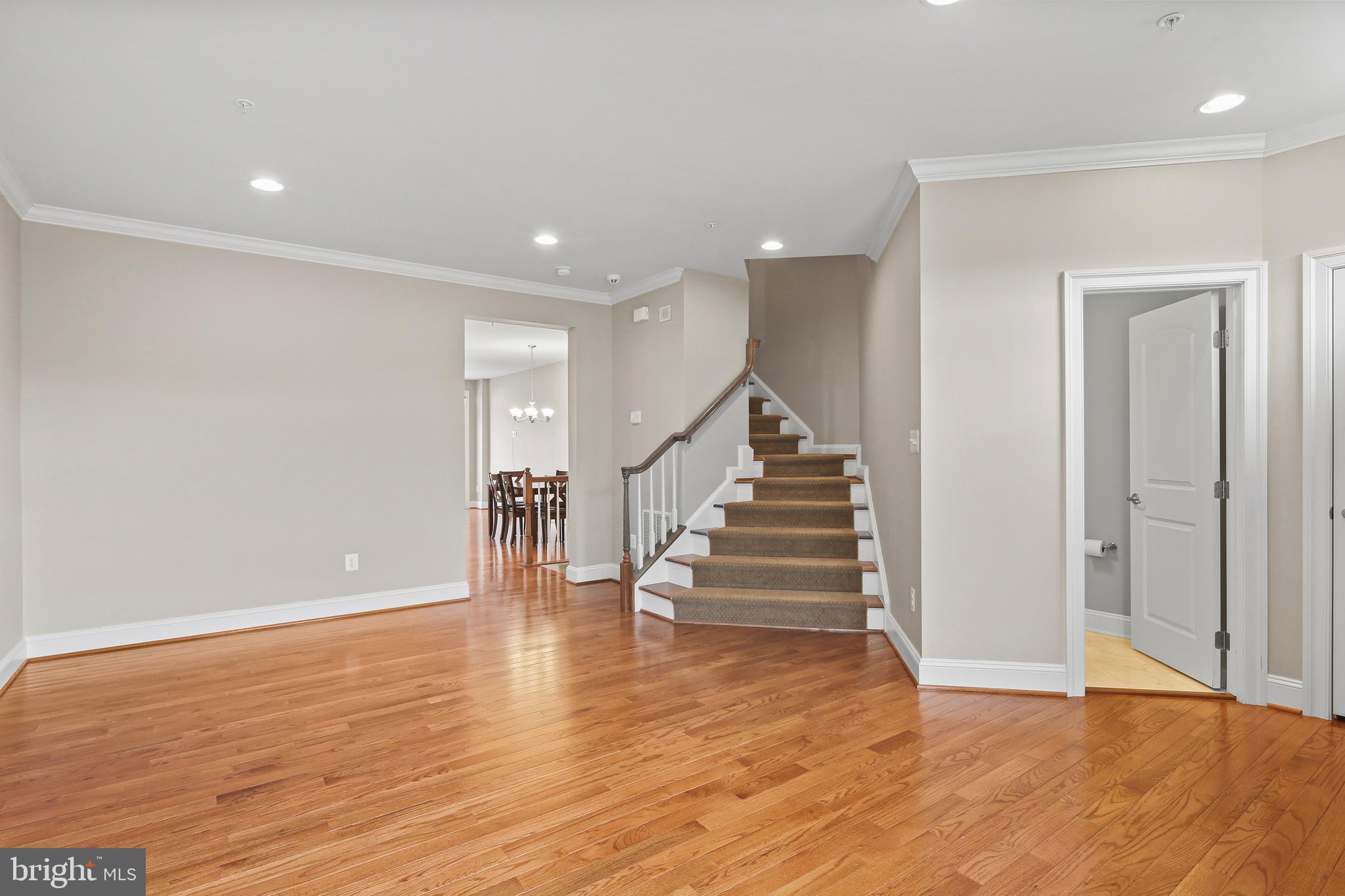 3553 Katherine Way Frederick, MD 21704 - Photo 20 of 34 a view of an empty room with wooden floor and stairs