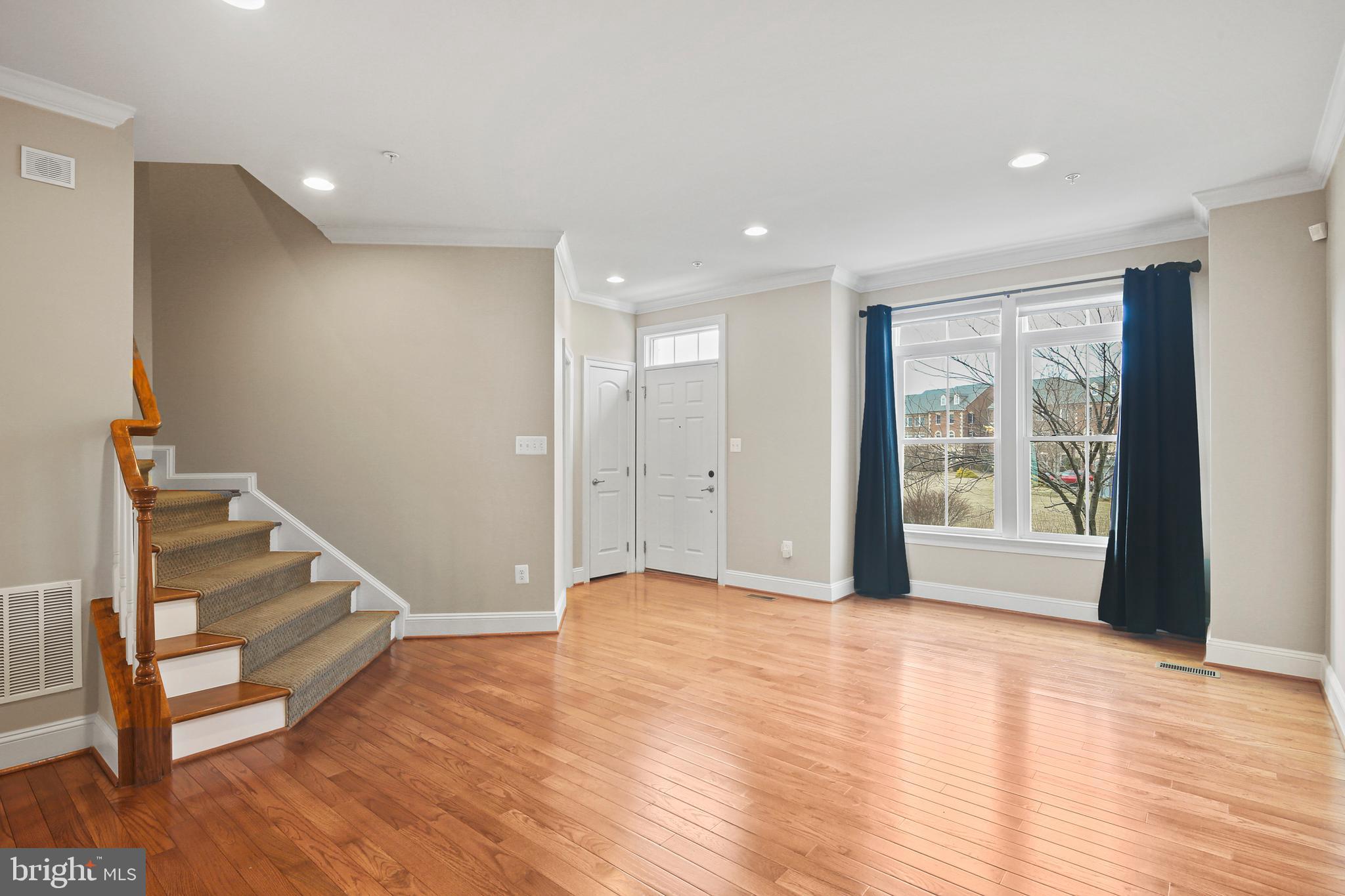 3553 Katherine Way Frederick, MD 21704 - Photo 21 of 34 a view of an empty room with wooden floor and stairs