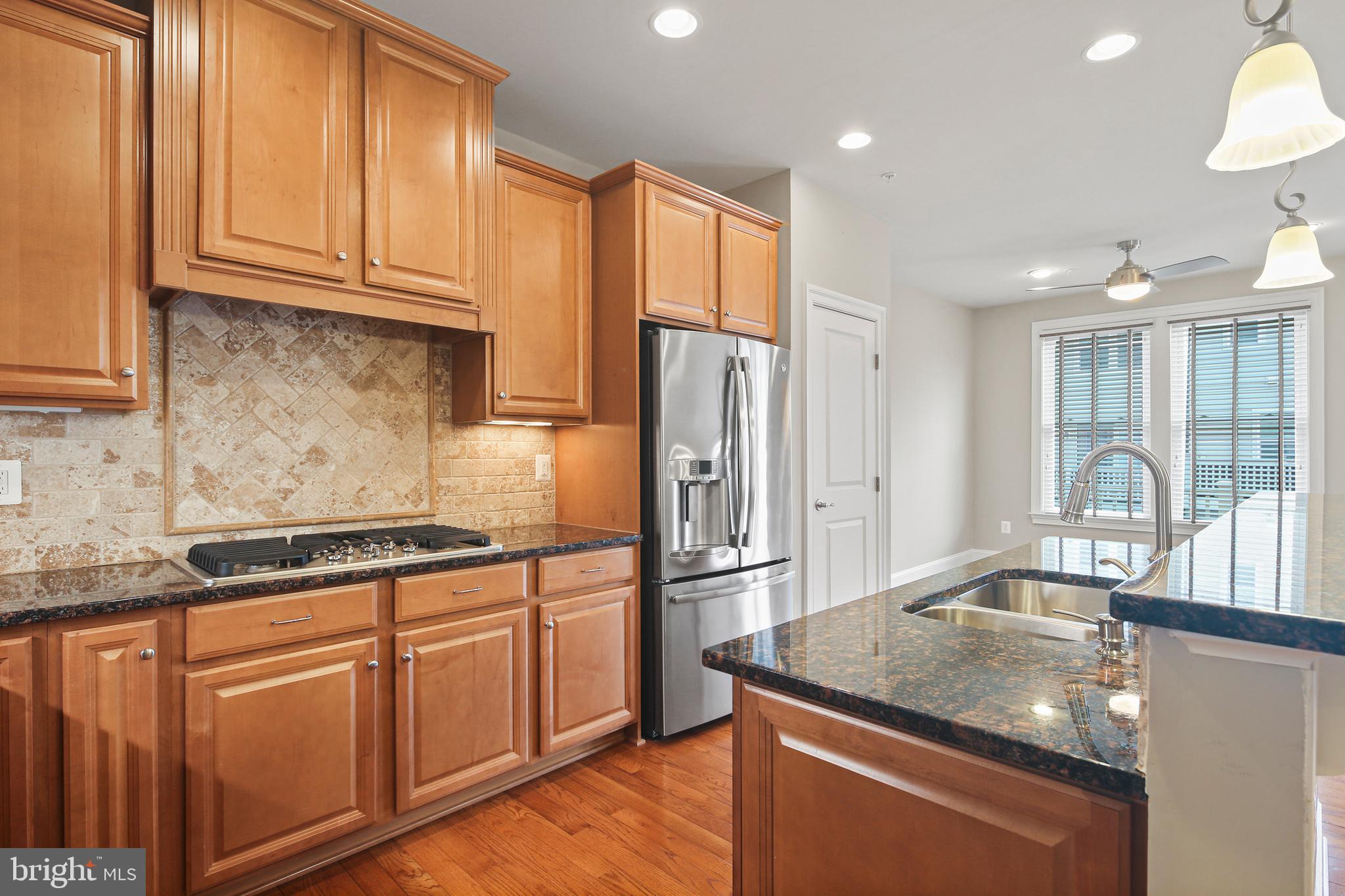 3553 Katherine Way Frederick, MD 21704 - Photo 23 of 34 a kitchen with stainless steel appliances granite countertop a sink a stove and a refrigerator