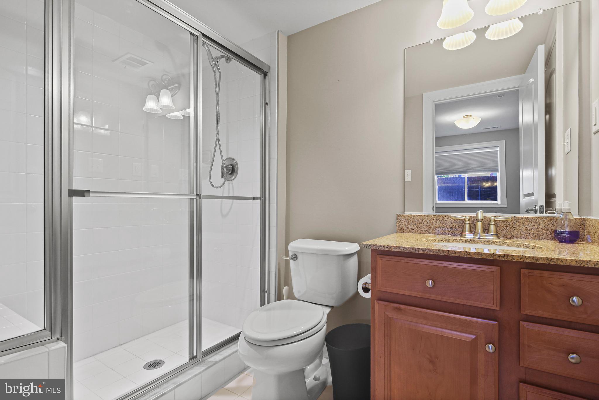 3553 Katherine Way Frederick, MD 21704 - Photo 32 of 34 a bathroom with a granite countertop sink toilet and shower