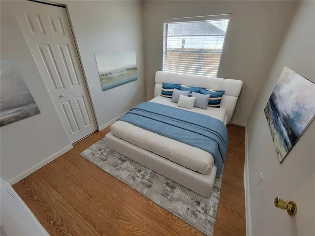 a bedroom with a bed and a window