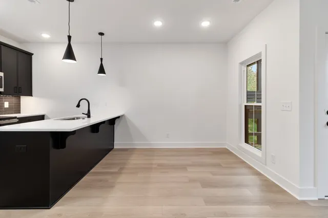 a kitchen with kitchen island a sink stainless steel appliances and cabinets