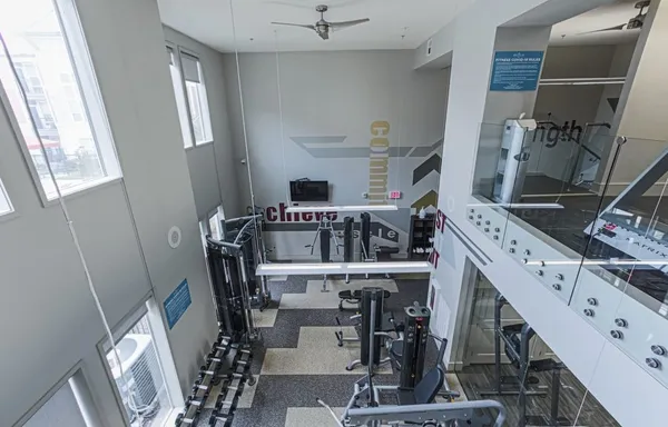 a living room with furniture a chandelier and a floor to ceiling window