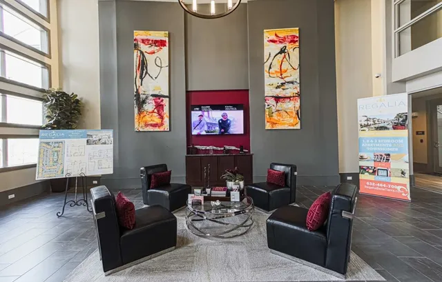 a view of a living room and kitchen with a stove