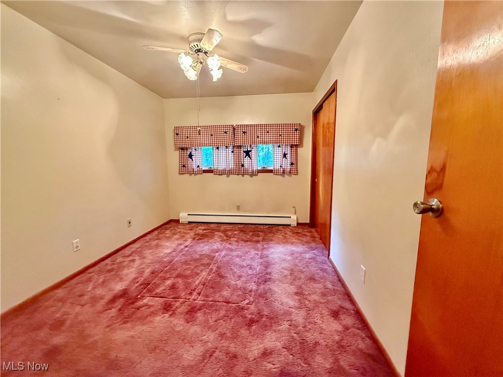 4878 Wylie Ridge Road New Cumberland, WV 26047 - Photo 10 of 20 Carpeted spare room with a baseboard radiator and ceiling fan