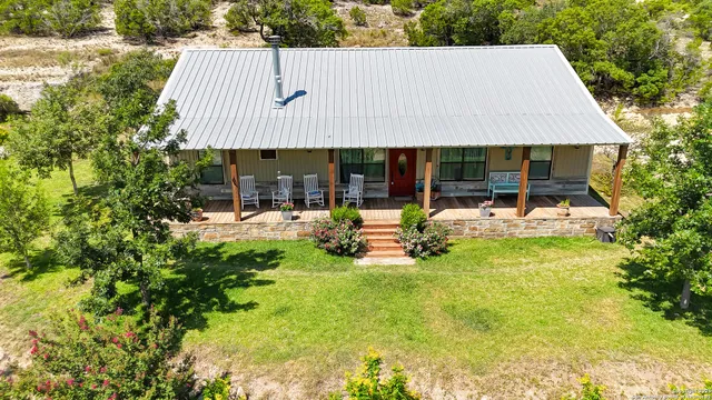 a view of a house with backyard porch and sitting area