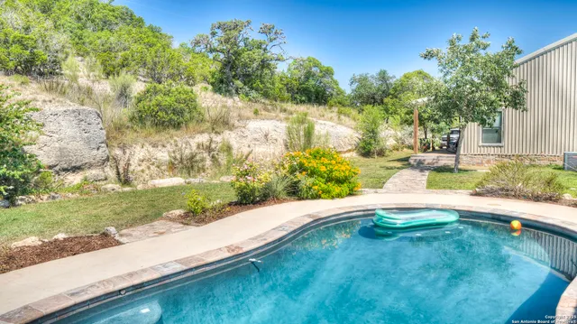 a view of a swimming pool with a patio