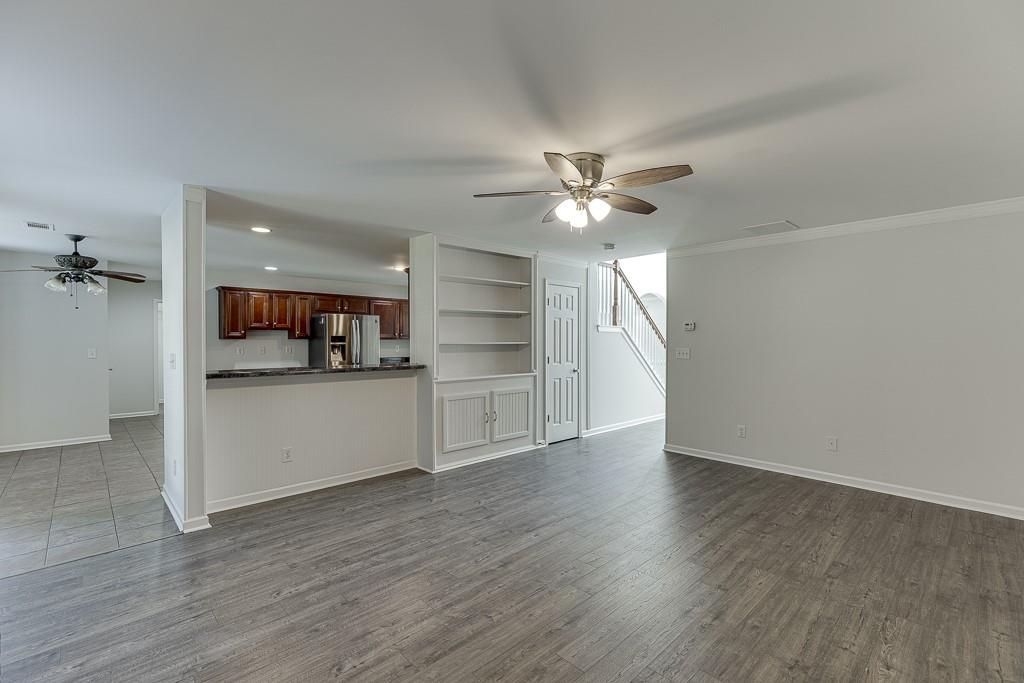926 Red Wolf Court Dacula, GA 30019 - Photo 11 of 47 a view of a kitchen with a dishwasher cabinets and a wooden floor