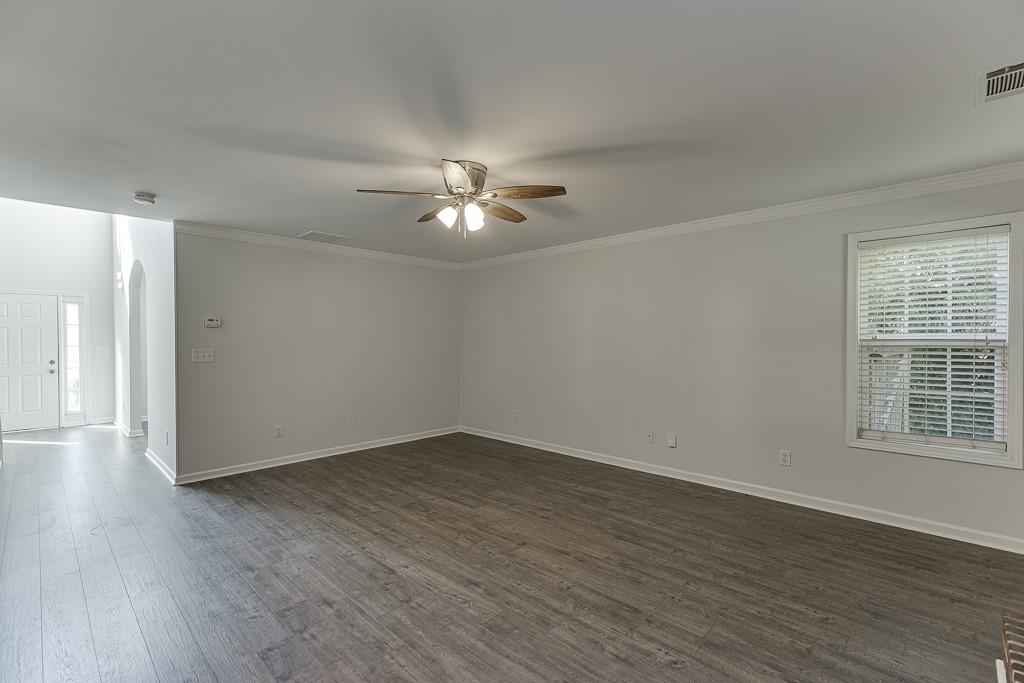 926 Red Wolf Court Dacula, GA 30019 - Photo 12 of 47 a view of an empty room with wooden floor and a window