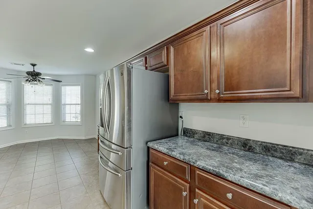 a kitchen with a refrigerator a stove and cabinets