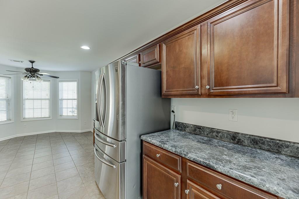 926 Red Wolf Court Dacula, GA 30019 - Photo 18 of 47 a kitchen with a refrigerator a stove and cabinets